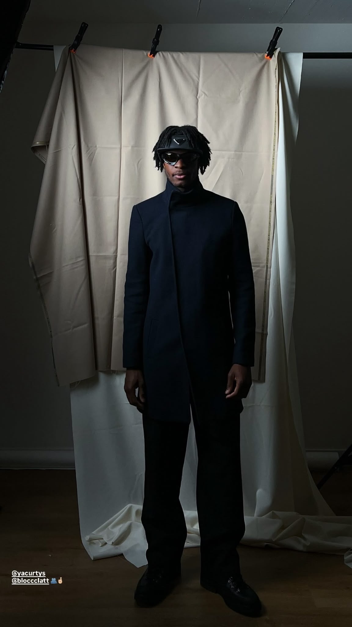 BLOCCCLATT studio portrait in a black coat